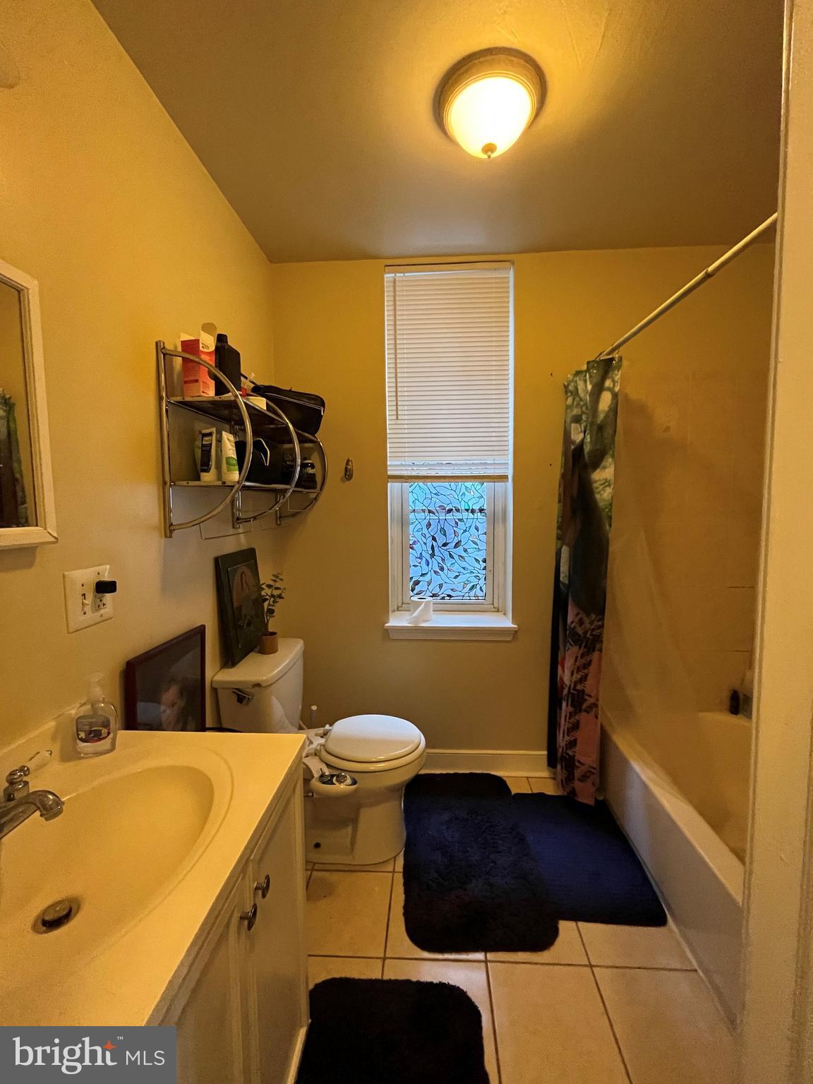 1429 West Norris Street, Unit 1 Philadelphia, PA 19121 - Photo 5 of 15 a bathroom with a sink and mirror with toilet