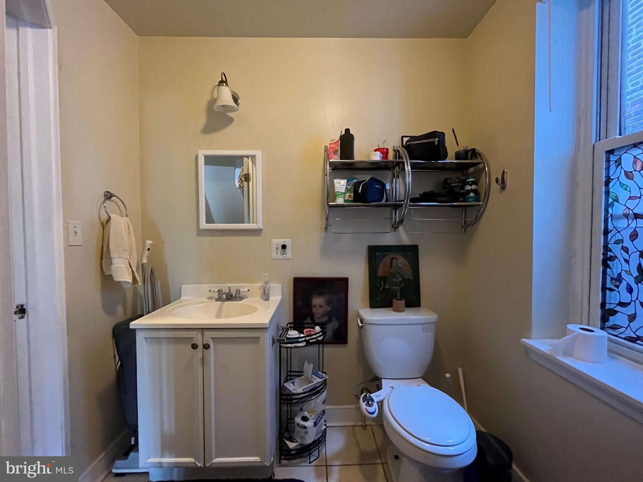 1429 West Norris Street, Unit 1 Philadelphia, PA 19121 - Photo 6 of 15 a bathroom with a toilet sink and mirror