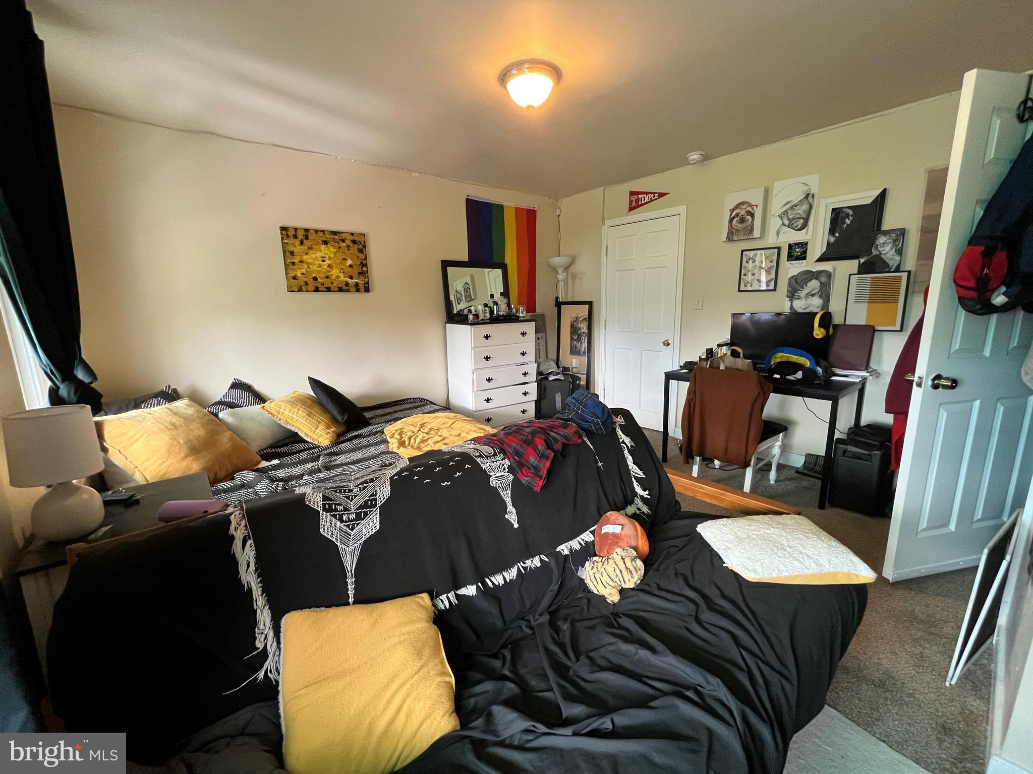 1429 West Norris Street, Unit 1 Philadelphia, PA 19121 - Photo 10 of 15 a bedroom with furniture and a flat screen tv