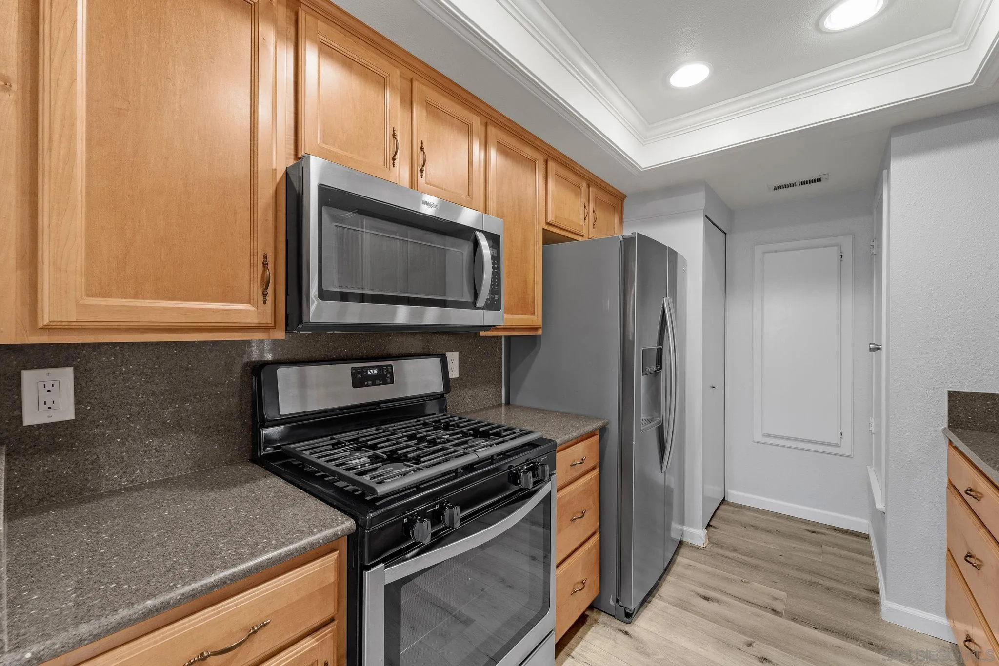 767 Brookstone Road, Unit 201 Chula Vista, CA 91913 - Photo 14 of 56 a kitchen with stainless steel appliances granite countertop a stove microwave and refrigerator