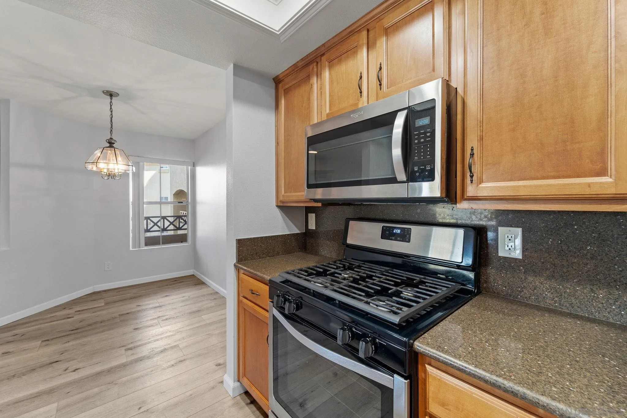 767 Brookstone Road, Unit 201 Chula Vista, CA 91913 - Photo 16 of 56 a kitchen with stainless steel appliances granite countertop a stove a microwave and a sink