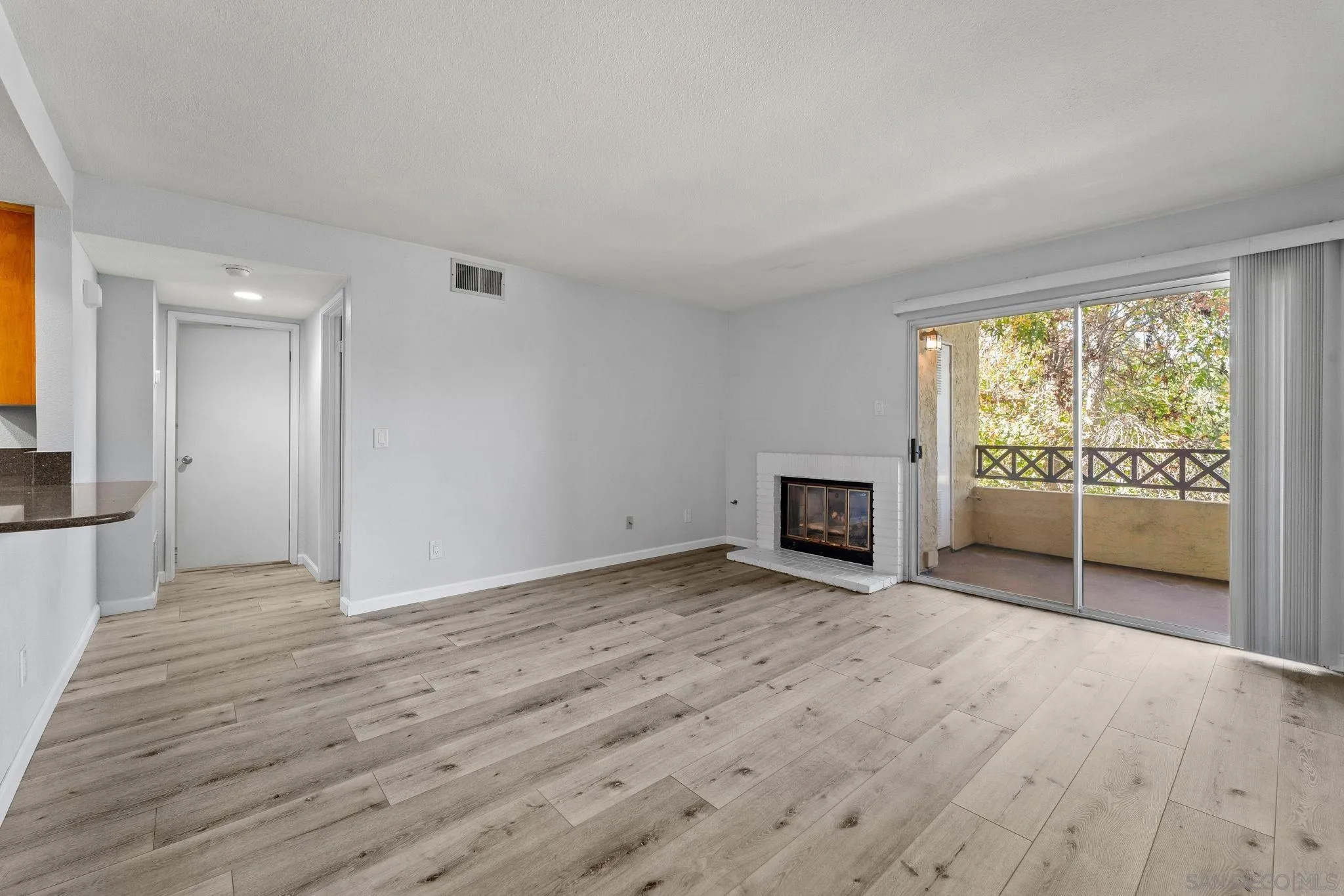 767 Brookstone Road, Unit 201 Chula Vista, CA 91913 - Photo 4 of 56 a view of a room with wooden floor a fireplace and window