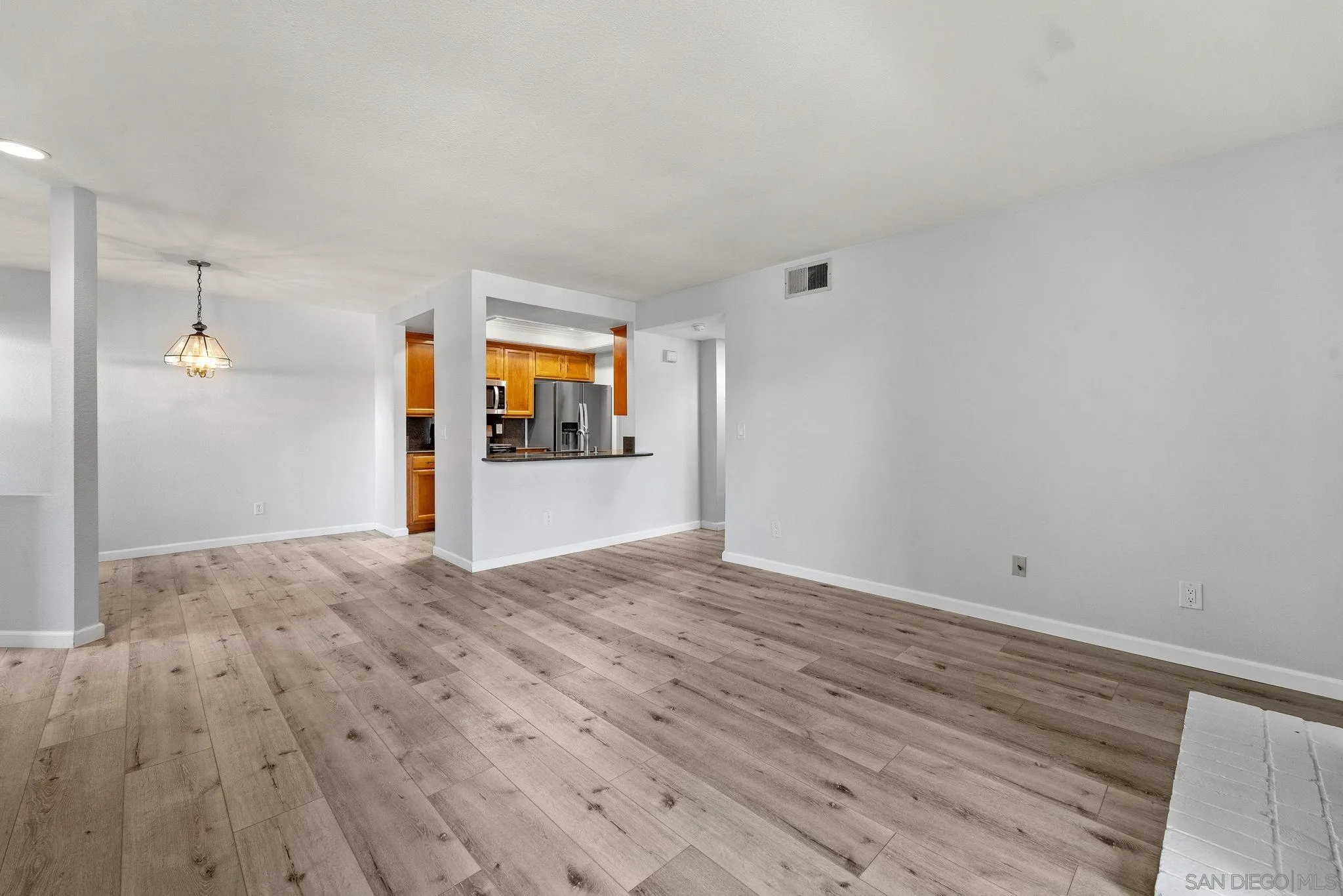 767 Brookstone Road, Unit 201 Chula Vista, CA 91913 - Photo 5 of 56 a view of empty room with wooden floor and fan