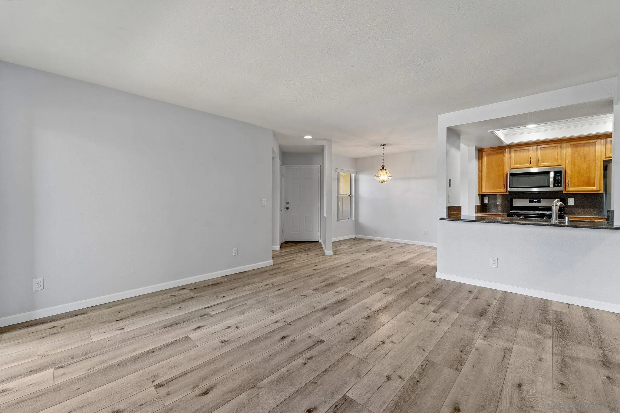 767 Brookstone Road, Unit 201 Chula Vista, CA 91913 - Photo 6 of 56 a view of empty room with wooden floor and a window