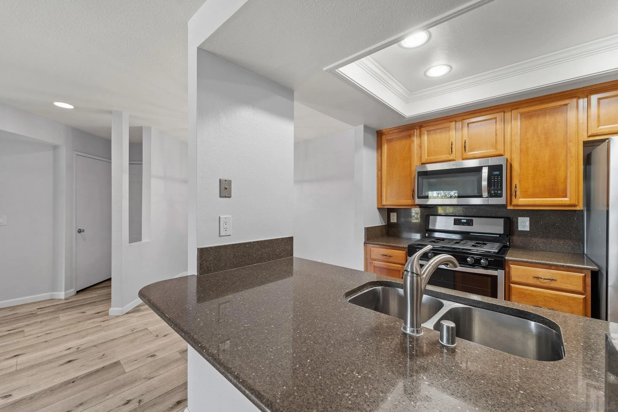 767 Brookstone Road, Unit 201 Chula Vista, CA 91913 - Photo 8 of 56 a kitchen with stainless steel appliances granite countertop a stove a sink and a microwave