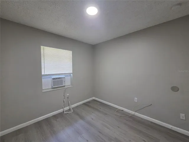 an empty room with wooden floor