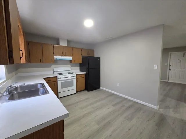 a kitchen with a stove a sink and a refrigerator