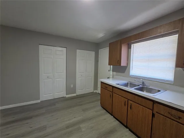 a kitchen with sink cabinets and wooden floor