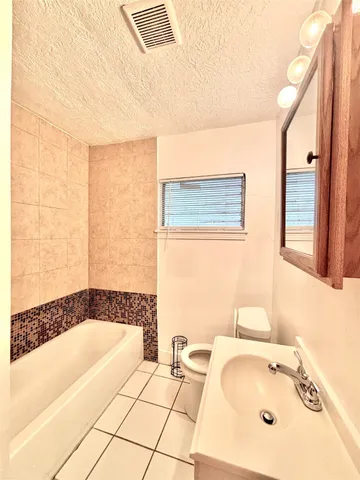 a bathroom with a bathtub and a sink