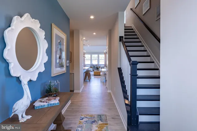 a hallway with furniture and wooden floor