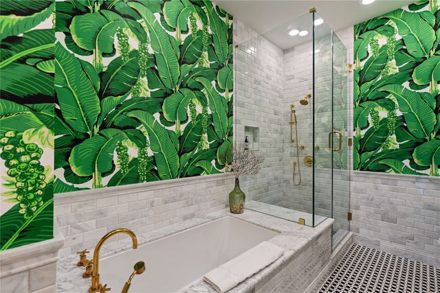 a bathroom with a granite countertop sink a mirror and a shower