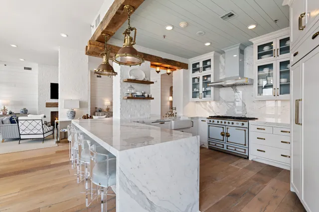 a large kitchen with stainless steel appliances kitchen island granite countertop a sink and cabinets
