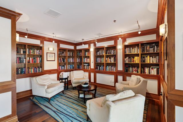 a living room with furniture and a book shelf