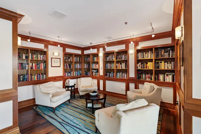a living room with furniture and a book shelf