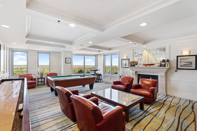 a living room with furniture kitchen view and a table