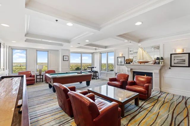 a living room with furniture kitchen view and a table