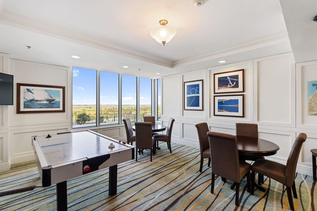 a view of a dining room with furniture a rug and wooden floor