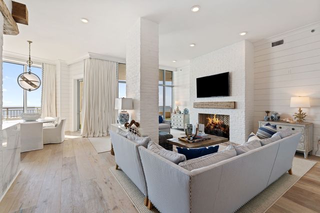 a living room with furniture fireplace and flat screen tv
