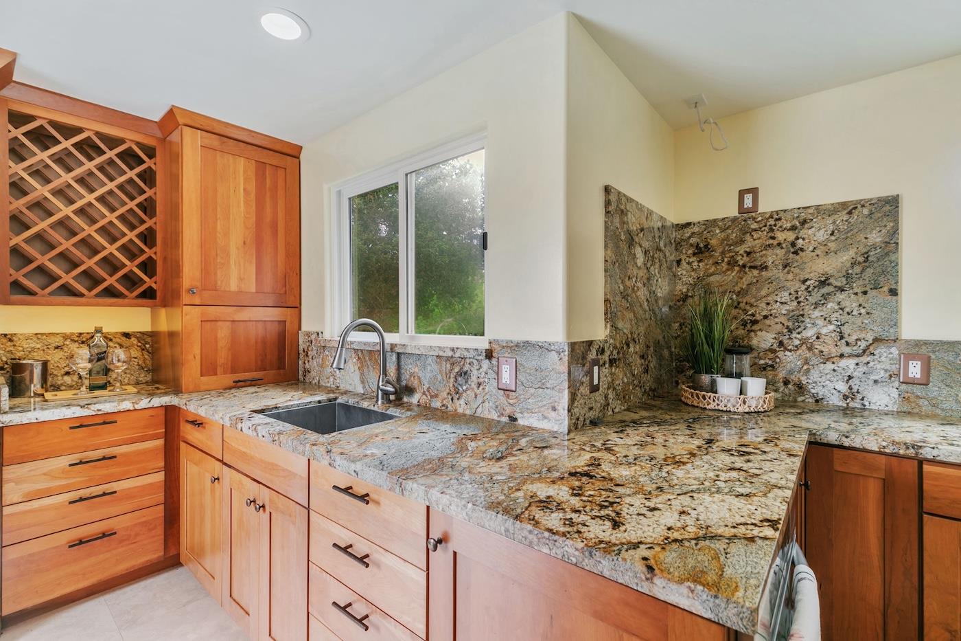 411 Hecker Pass Road Watsonville, CA 95076 - Photo 11 of 76 a bathroom with a granite countertop sink and a mirror