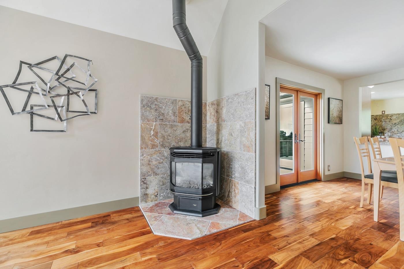 411 Hecker Pass Road Watsonville, CA 95076 - Photo 17 of 76 a view of a livingroom with wooden floor and a kitchen space