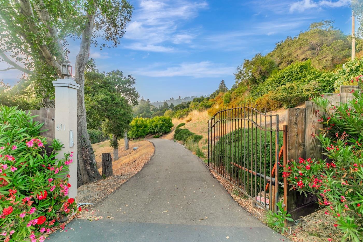 411 Hecker Pass Road Watsonville, CA 95076 - Photo 2 of 76 a view of a pathway with a flower garden