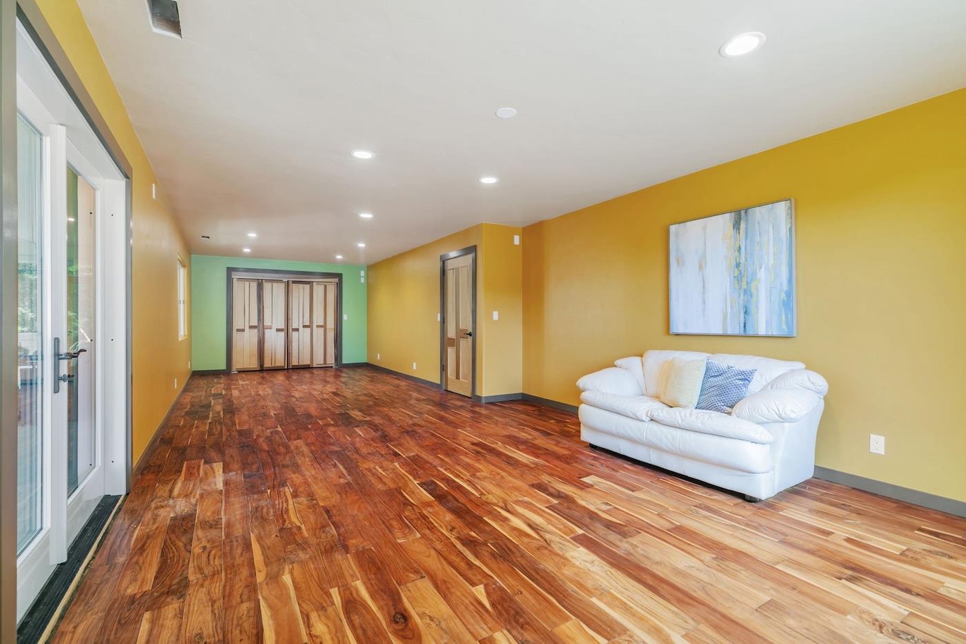411 Hecker Pass Road Watsonville, CA 95076 - Photo 23 of 76 a view of a livingroom with furniture and wooden floor