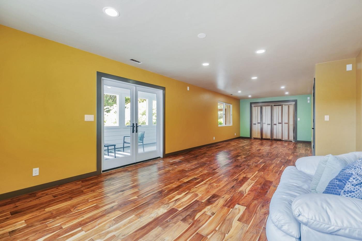 411 Hecker Pass Road Watsonville, CA 95076 - Photo 24 of 76 a view of an empty room with wooden floor and a window