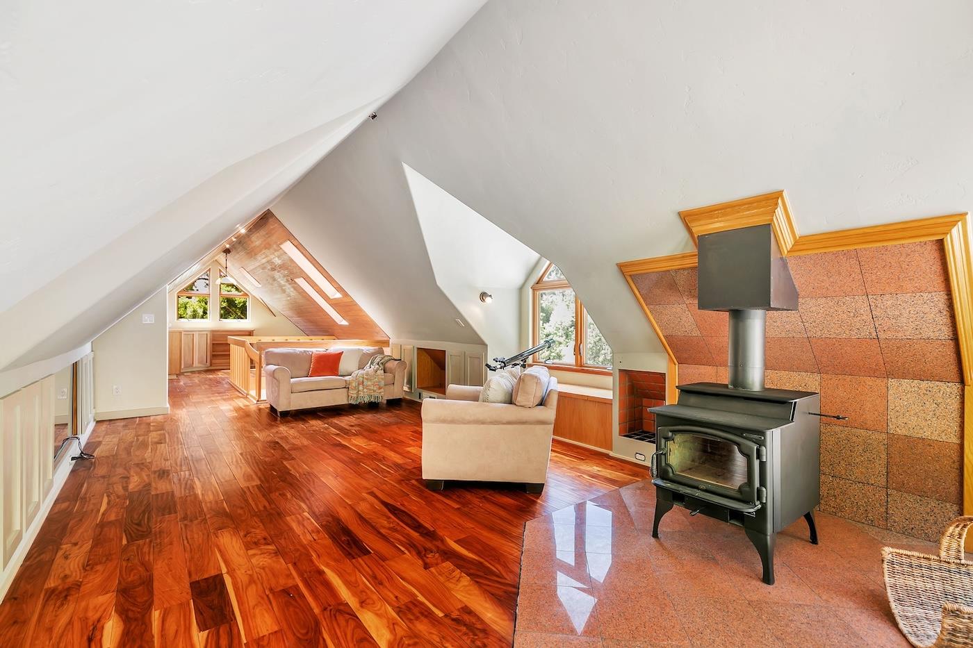 411 Hecker Pass Road Watsonville, CA 95076 - Photo 38 of 76 a living room with furniture and a wooden floor