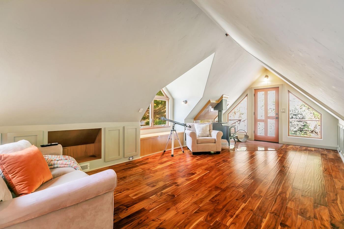 411 Hecker Pass Road Watsonville, CA 95076 - Photo 40 of 76 a living room with furniture and a wooden floor