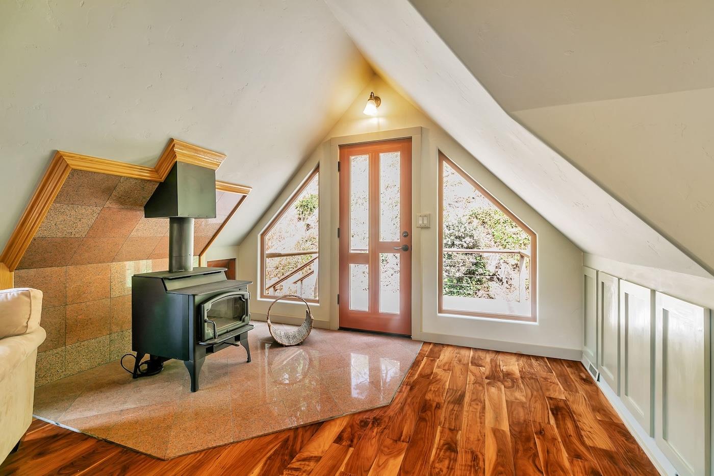 411 Hecker Pass Road Watsonville, CA 95076 - Photo 41 of 76 a dining room with wooden floor and windows