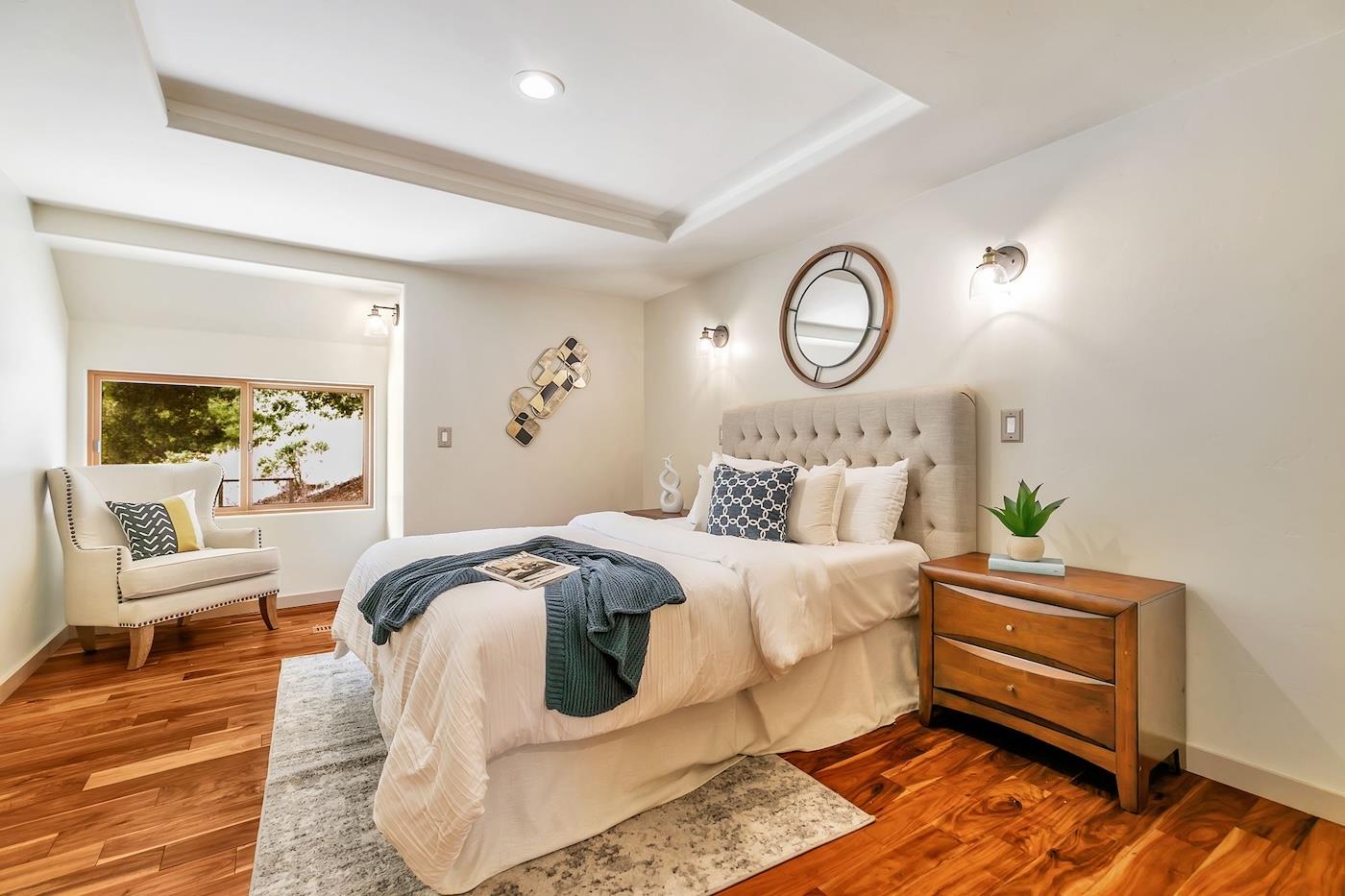 411 Hecker Pass Road Watsonville, CA 95076 - Photo 44 of 76 a bedroom with a bed and wooden floor