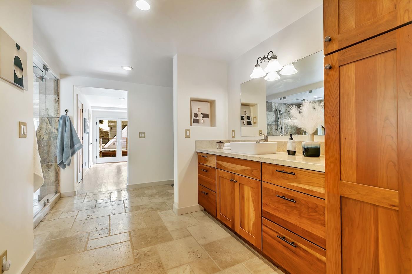 411 Hecker Pass Road Watsonville, CA 95076 - Photo 51 of 76 a spacious bathroom with a granite countertop sink mirror and a shower