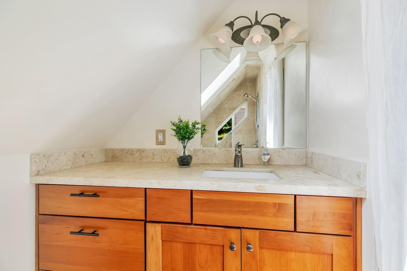 411 Hecker Pass Road Watsonville, CA 95076 - Photo 55 of 76 a bathroom with a granite countertop sink and a mirror
