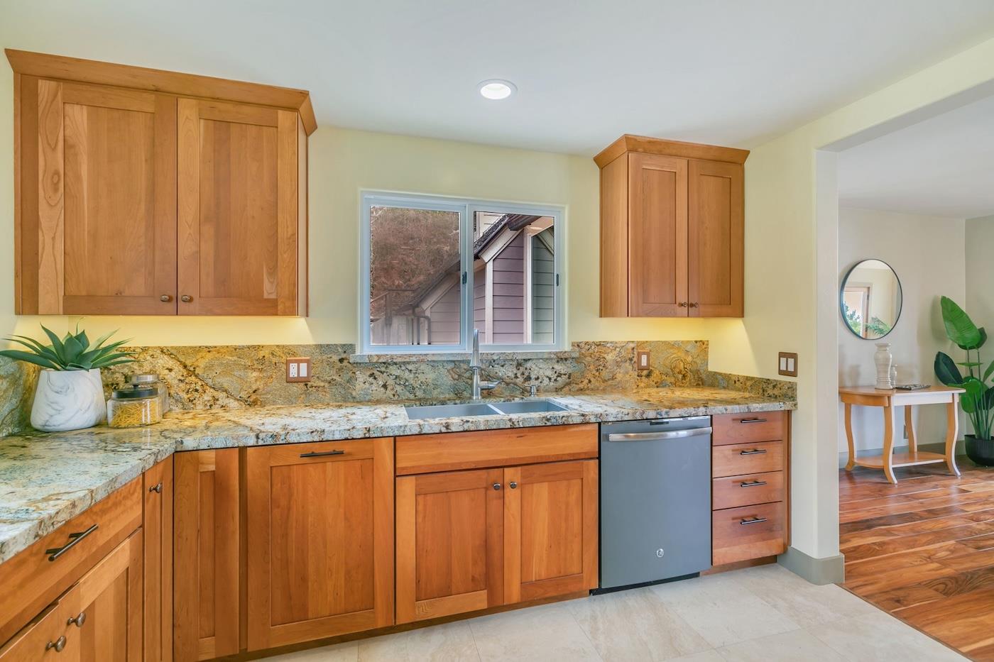 411 Hecker Pass Road Watsonville, CA 95076 - Photo 7 of 76 a kitchen with granite countertop a sink and cabinets