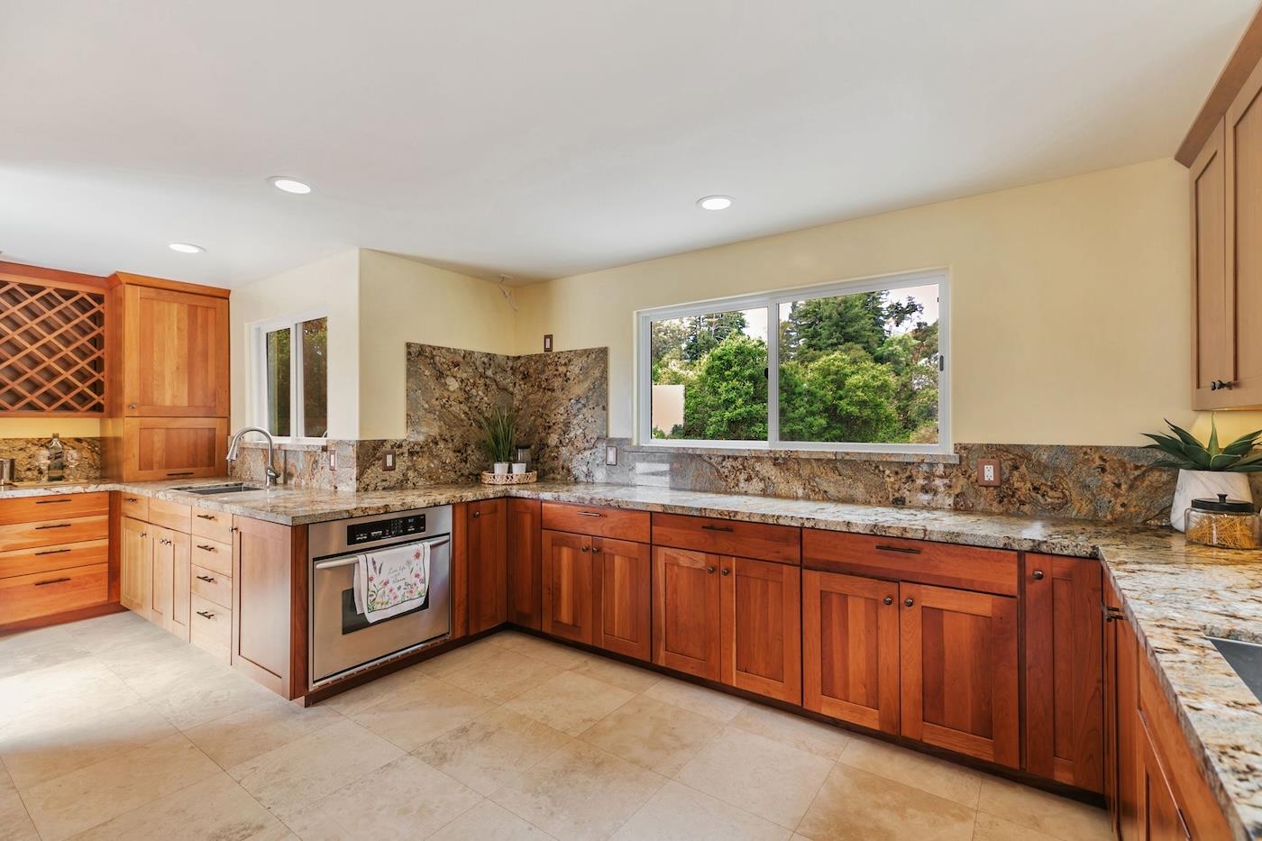 411 Hecker Pass Road Watsonville, CA 95076 - Photo 8 of 76 a kitchen with stainless steel appliances granite countertop a stove and cabinets