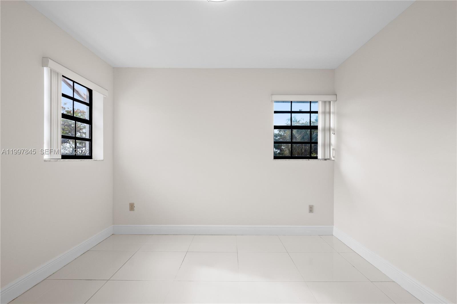 6211 Southwest 138th Court, Unit B Miami, FL 33183 - Photo 23 of 27 an empty room with windows