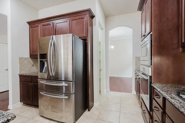 a kitchen with a refrigerator and a sink