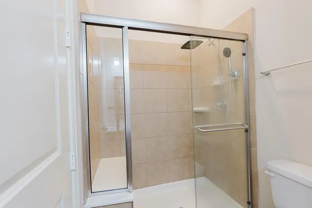 a bathroom with a glass shower door