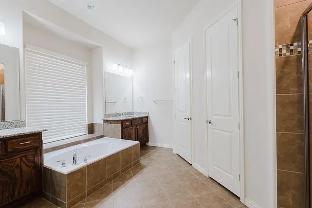 a spacious bathroom with a bathtub and a sink