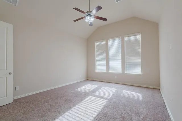 a view of room with a ceiling fan and window