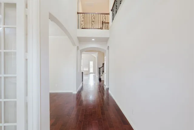 a view of a hallway with wooden floor