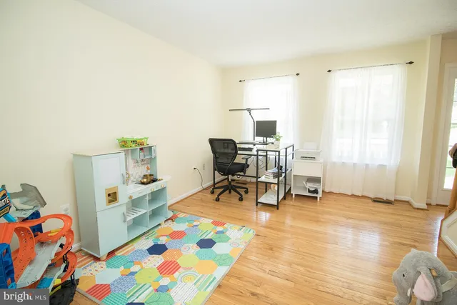 a kitchen with stainless steel appliances granite countertop a stove top oven a sink and a refrigerator