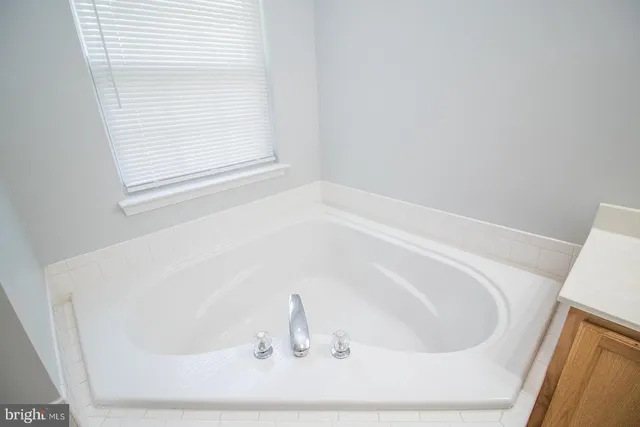 a white bath tub sitting in a bathroom