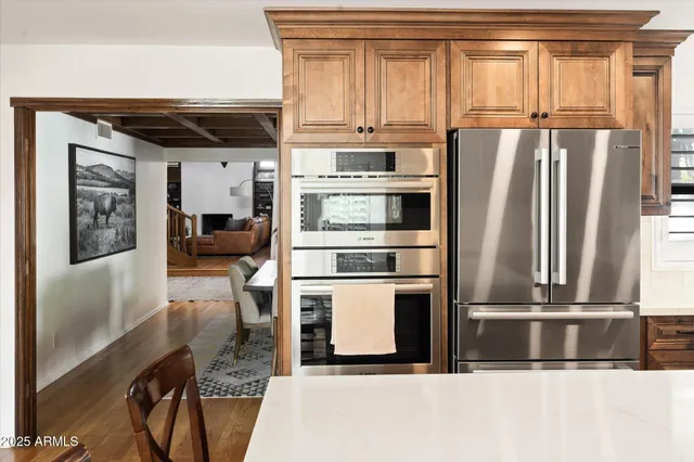 a living room with furniture and a dining table with rug
