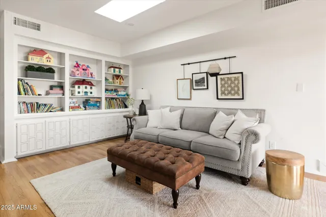 a kitchen with stainless steel appliances kitchen island granite countertop a table chairs in it and wooden floors