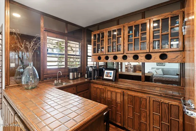 a large bed sitting in a bedroom next to a window with a lamp and a table