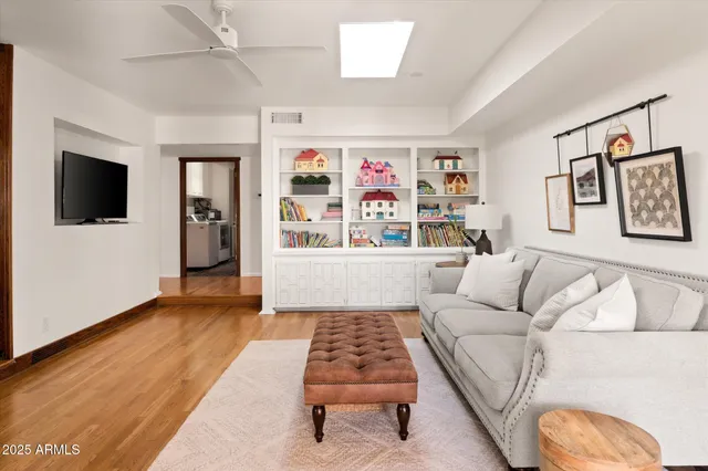 a room with gym equipment and wooden floor