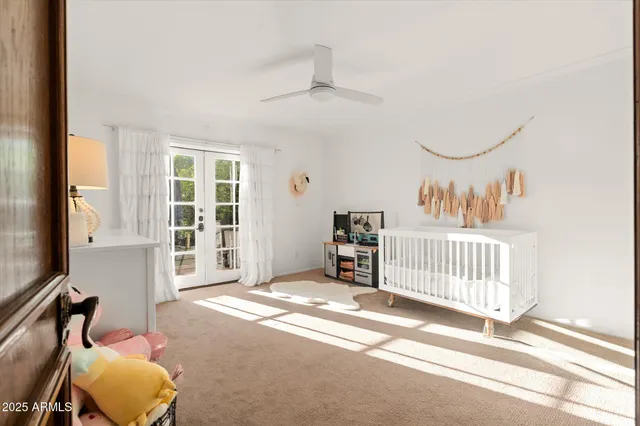 a living room with furniture a bookshelf and a large window