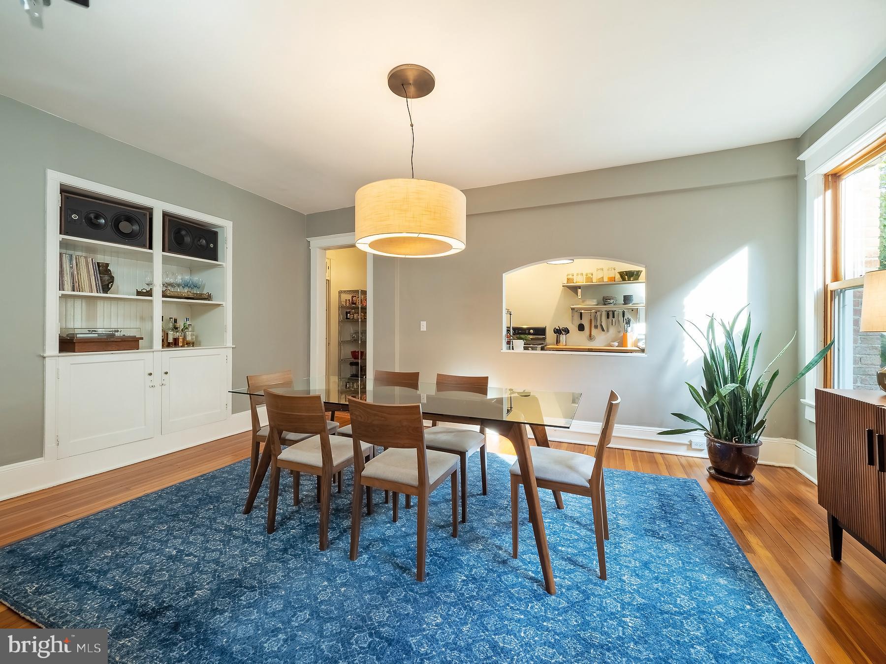 1736 Columbia Road Northwest, Unit 309 Washington, DC 20009 - Photo 13 of 38 a dining room with wooden floor a chandelier a wooden table and chairs