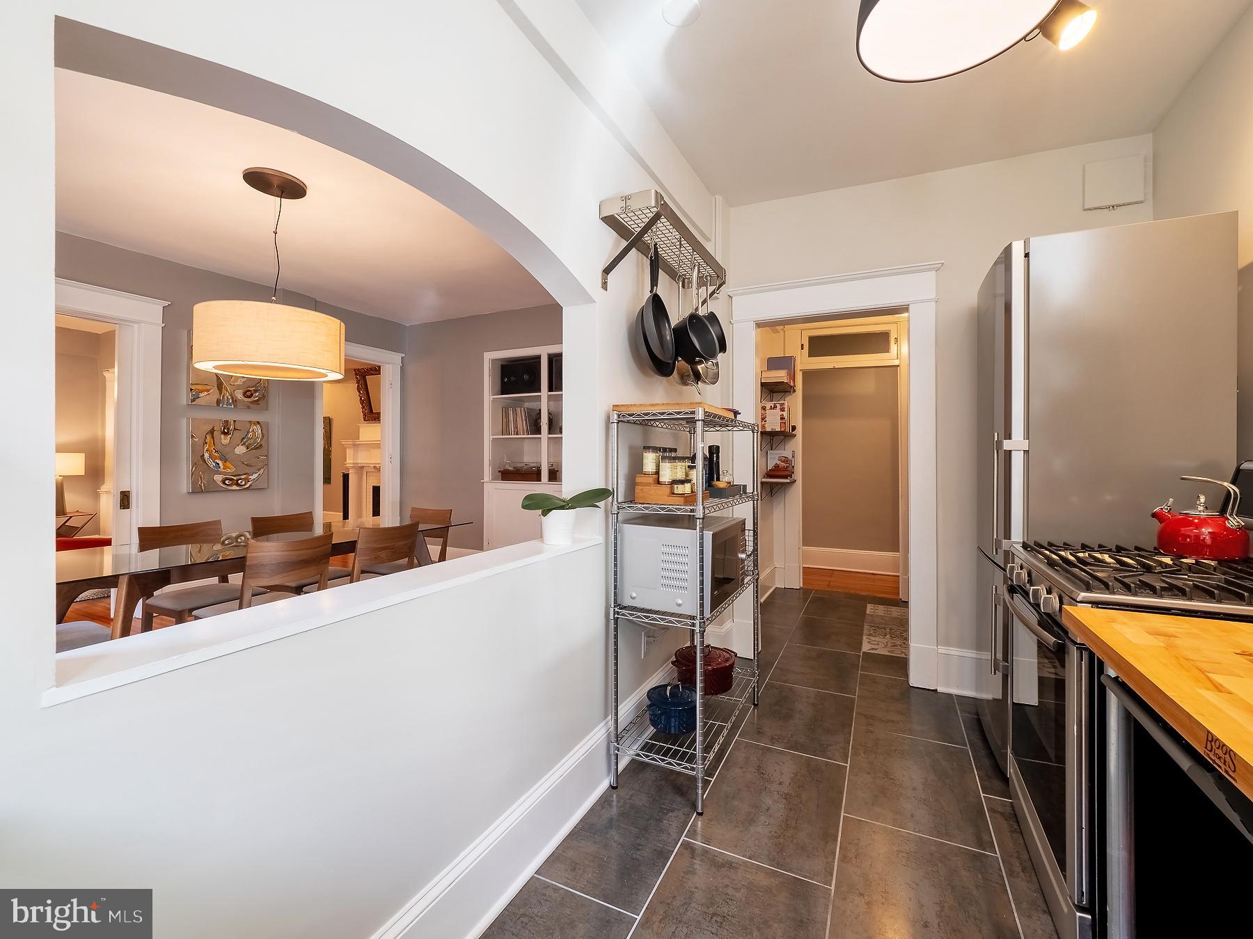 1736 Columbia Road Northwest, Unit 309 Washington, DC 20009 - Photo 17 of 38 a kitchen with stainless steel appliances a sink stove and refrigerator